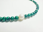 The Bì(碧) handcrafted necklace featuring lustrous white pearls and vibrant green malachite stones arranged in elegant pattern