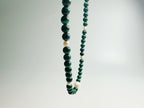 The Bì(碧) handcrafted necklace featuring lustrous white pearls and vibrant green malachite stones arranged in elegant pattern